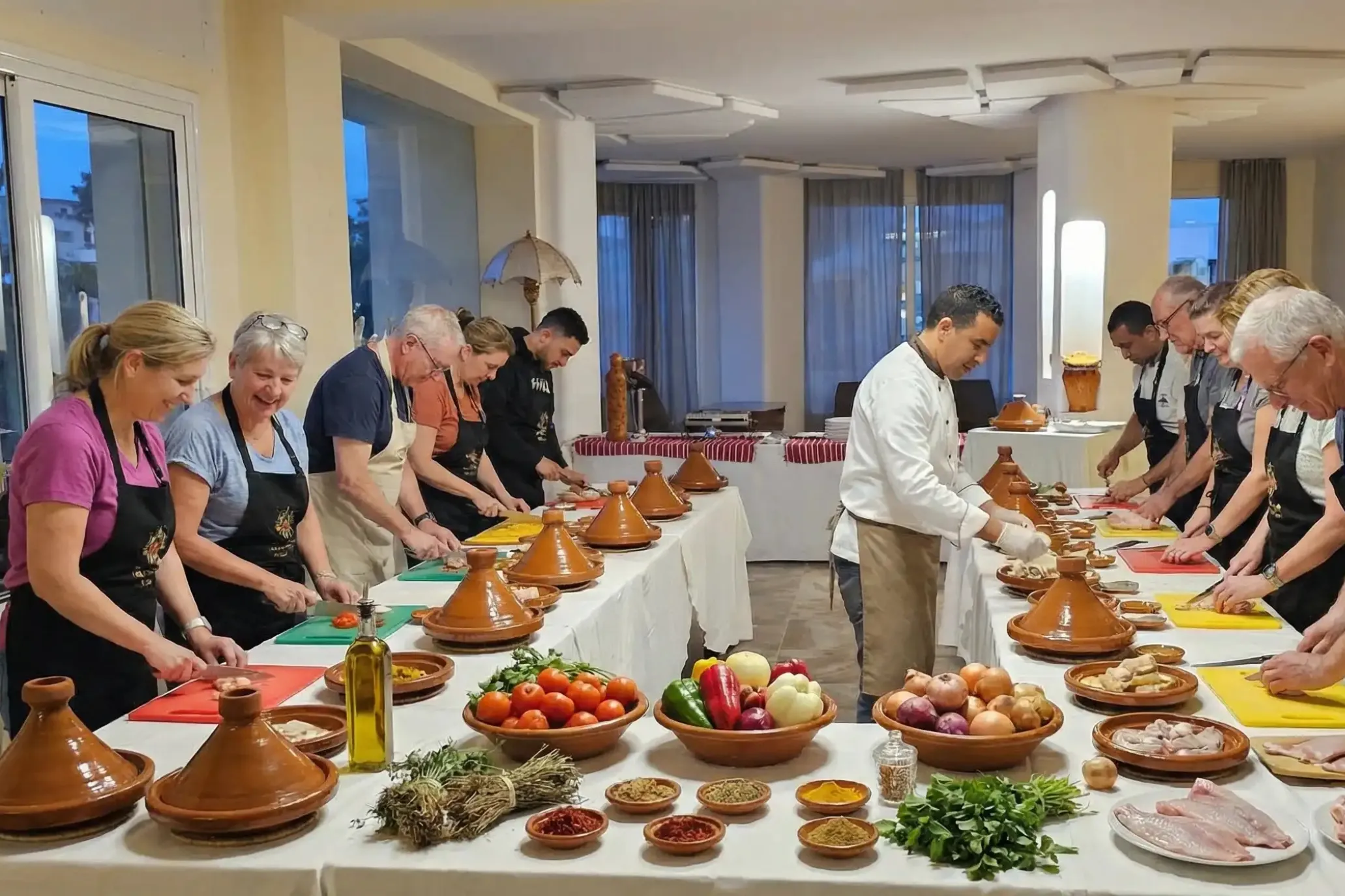 Moroccan chef guiding guests during a cooking class